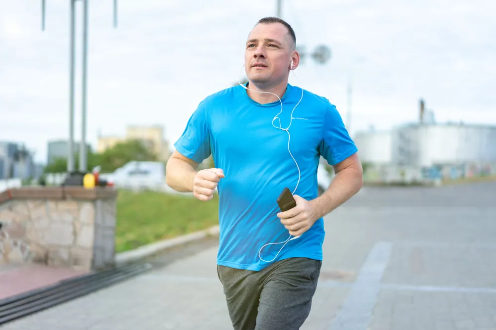 Man jogging outdoors, representing men's health care